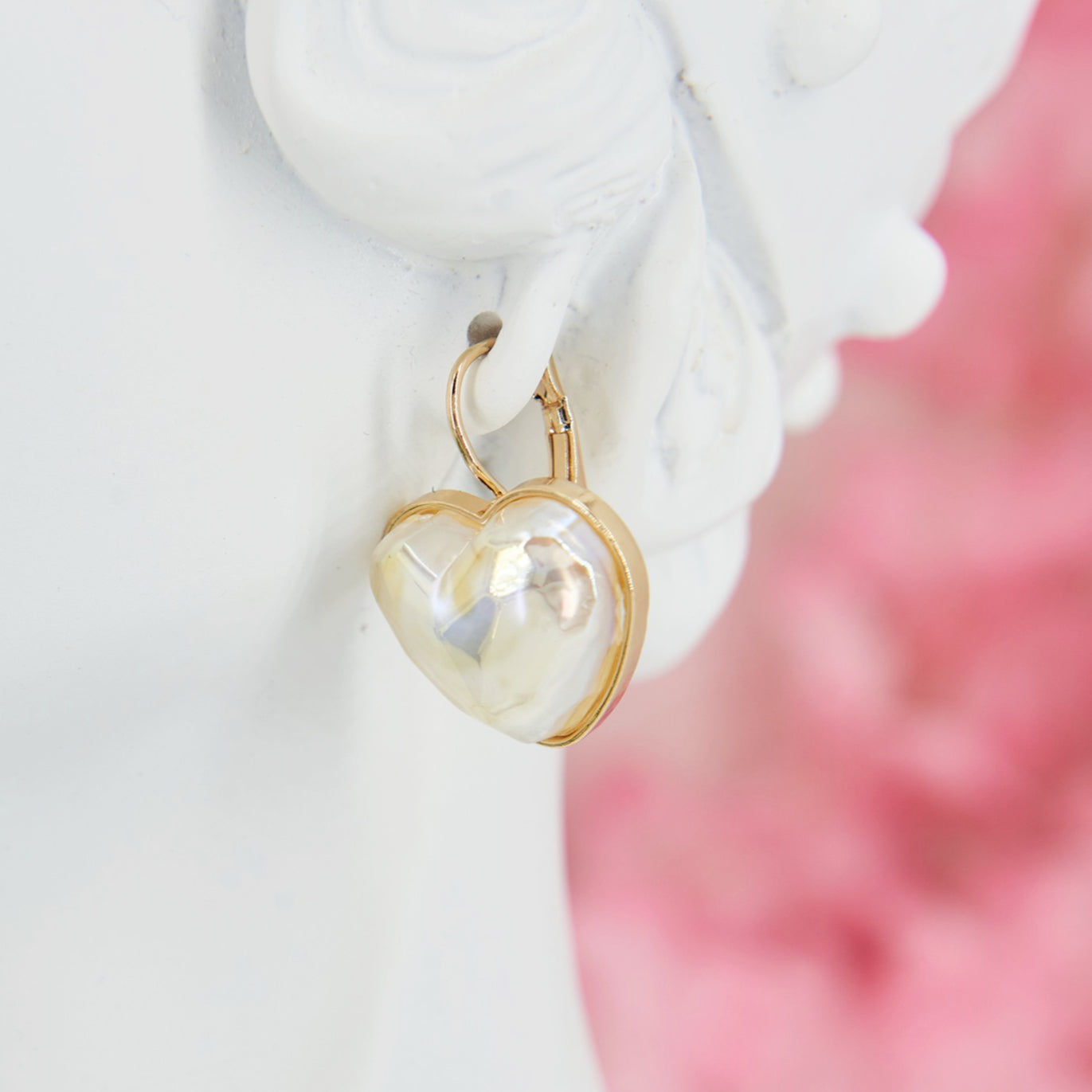 Delicate and romantic heart shaped earrings with iridescent reflections, perfect for weddings and special occasions.