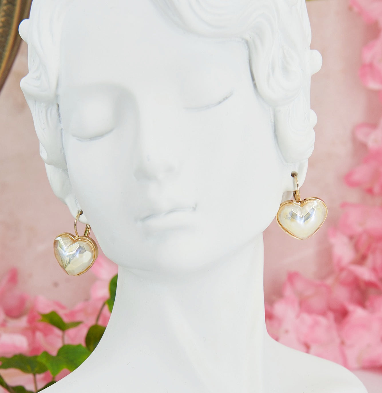 Delicate and romantic heart shaped earrings with iridescent reflections, perfect for weddings and special occasions.