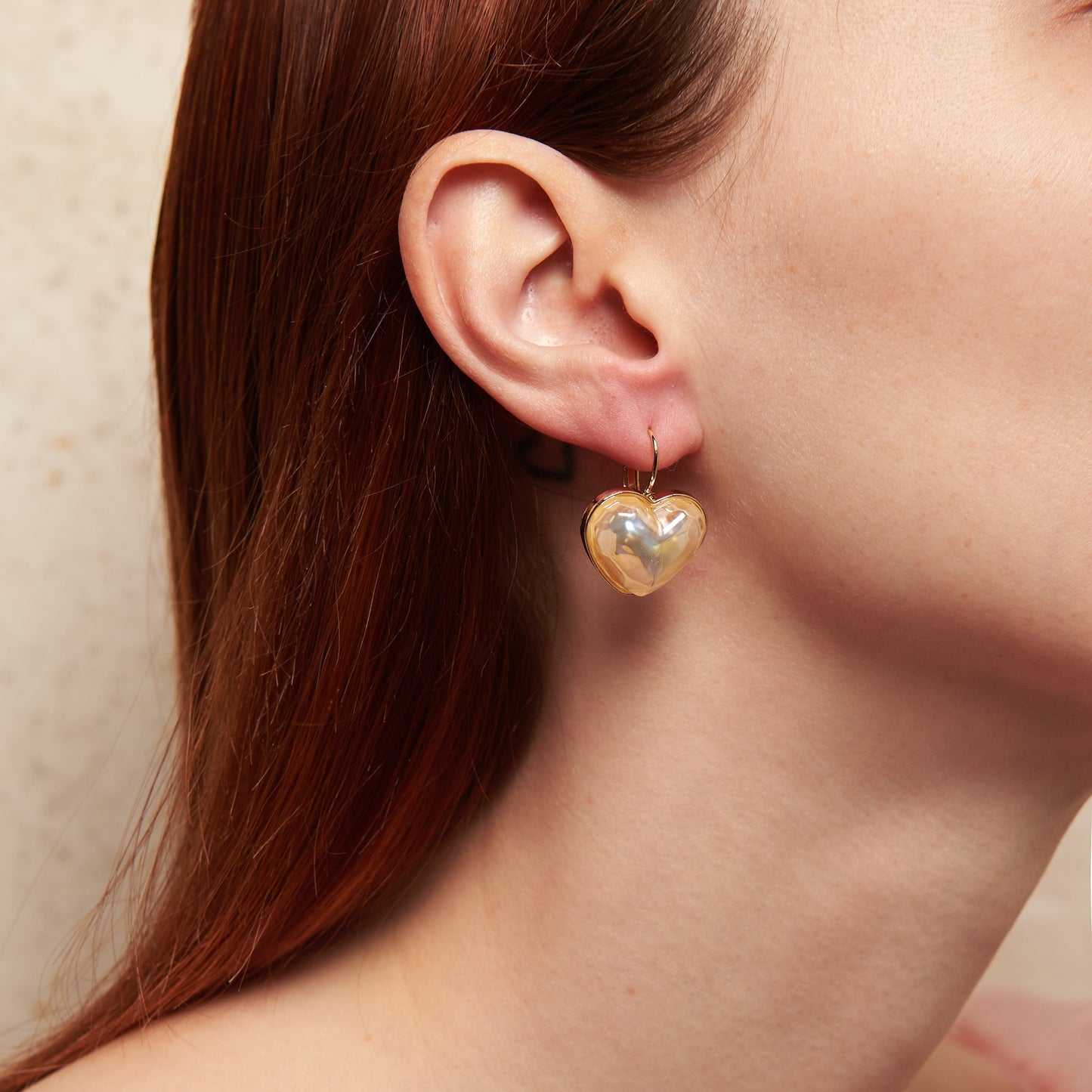 Delicate and romantic heart shaped earrings with iridescent reflections, perfect for weddings and special occasions.