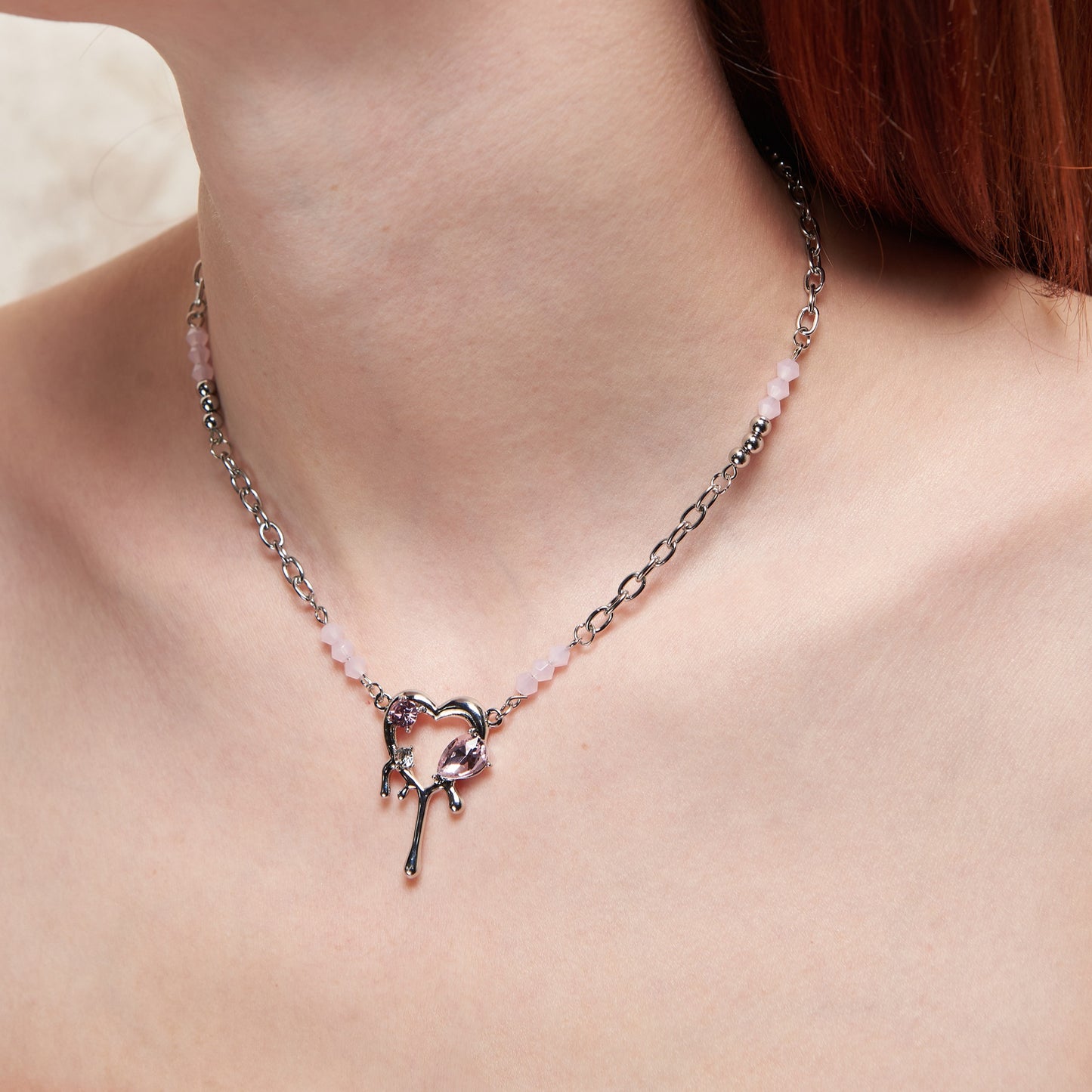 Y2K-inspired necklace with a silver-tone adjustable chain and a dripping heart pendant adorned with pink zircons. A blend of retro charm and modern shine, perfect for a nostalgic yet trendy look.