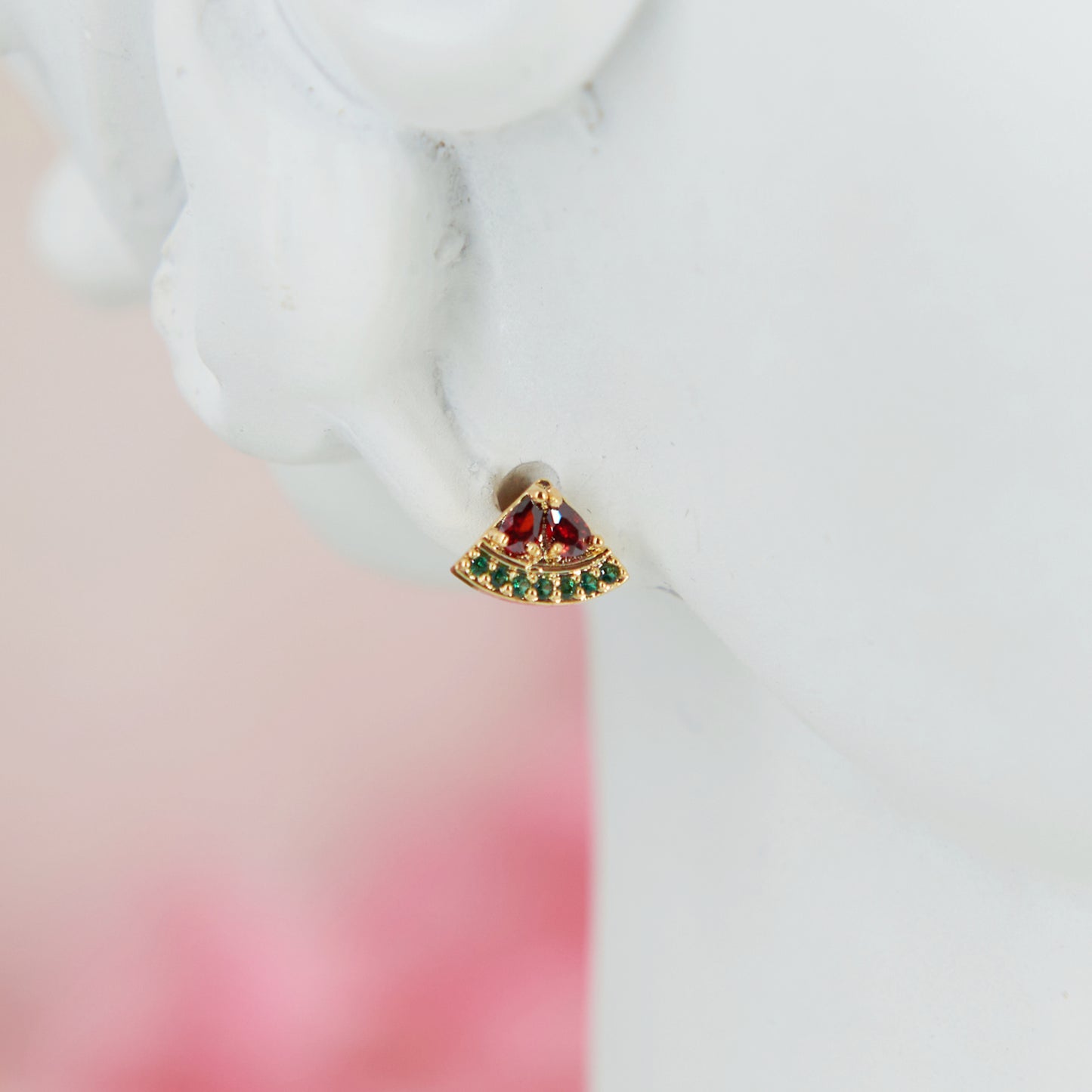 Mini watermelon-shaped earrings, 0.5 cm. Cute, minimalist, and summery. Made with cubic zirconia and metal alloy for a fresh seasonal touch.