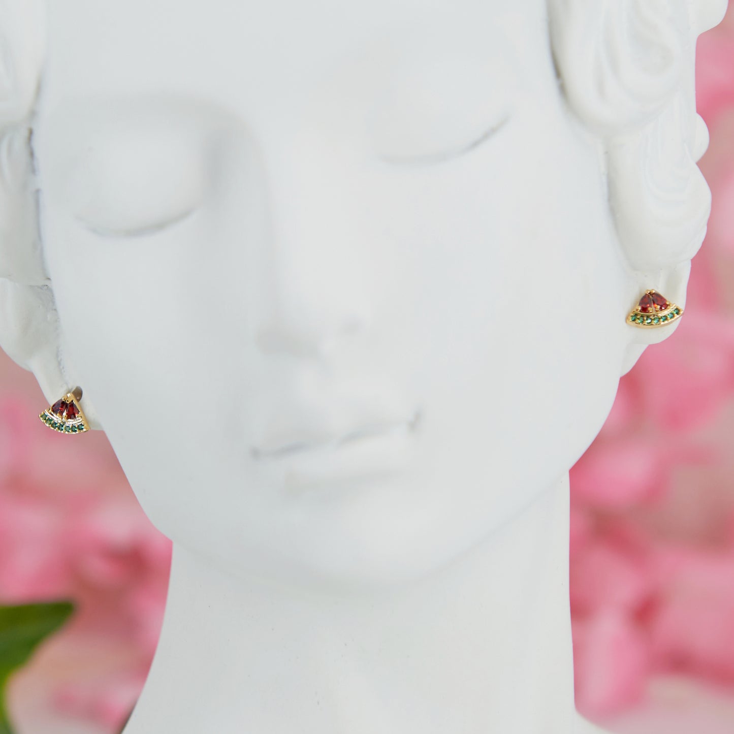 Mini watermelon-shaped earrings, 0.5 cm. Cute, minimalist, and summery. Made with cubic zirconia and metal alloy for a fresh seasonal touch.