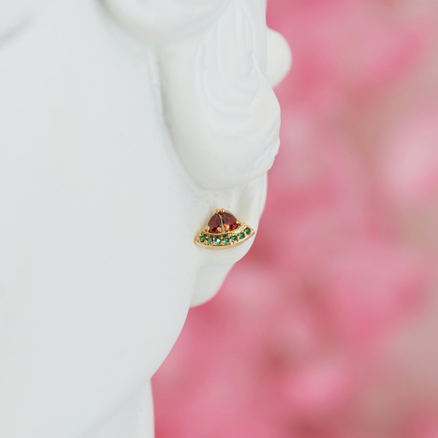 Mini watermelon-shaped earrings, 0.5 cm. Cute, minimalist, and summery. Made with cubic zirconia and metal alloy for a fresh seasonal touch.