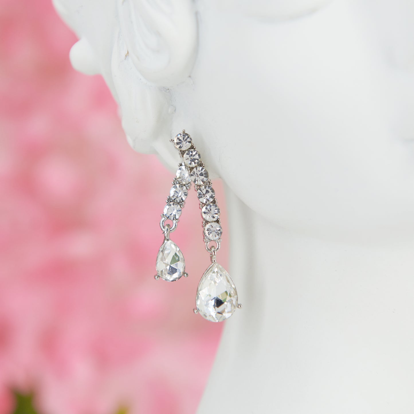 Big crystal glamour earrings in zinc alloy with zircons. 4.5 cm long. Removable back for a customizable, chic, and bright style.