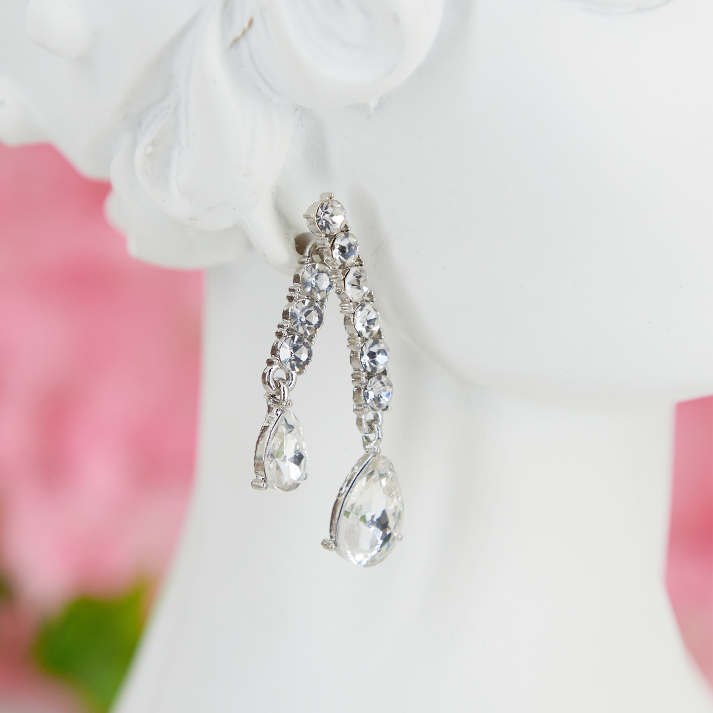 Big crystal glamour earrings in zinc alloy with zircons. 4.5 cm long. Removable back for a customizable, chic, and bright style.