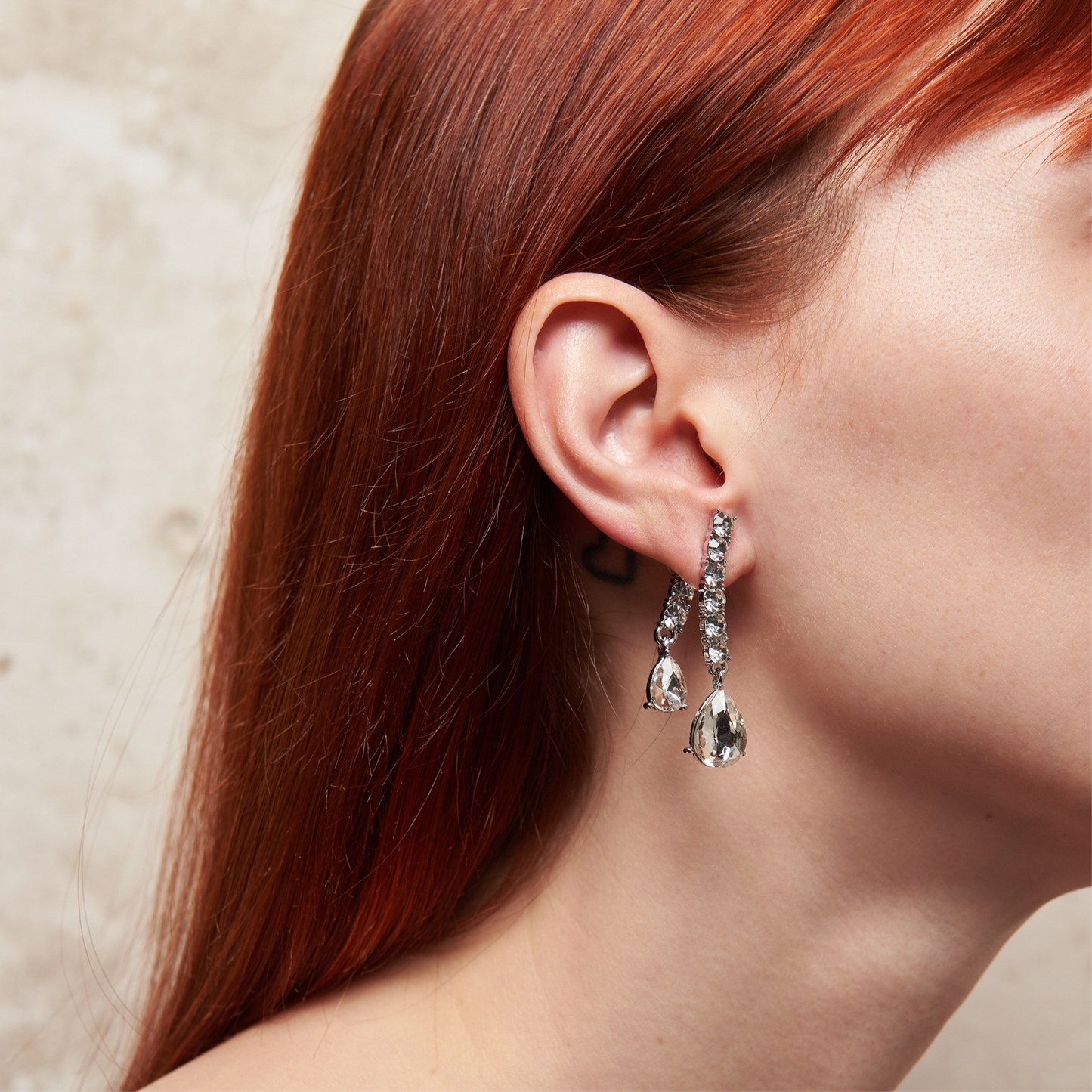 Big crystal glamour earrings in zinc alloy with zircons. 4.5 cm long. Removable back for a customizable, chic, and bright style.