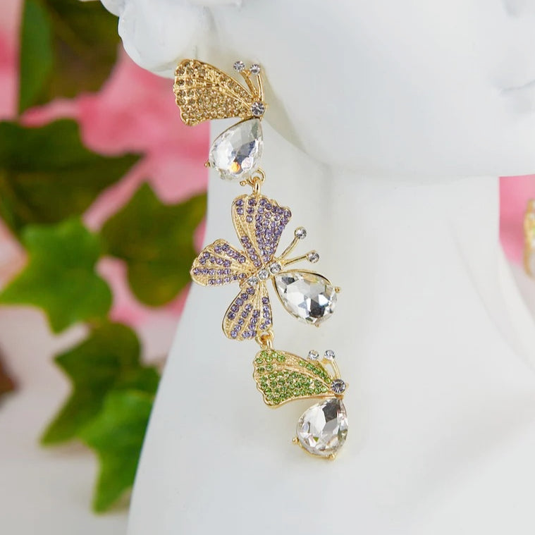 Statement maxi drop earrings with three golden butterflies adorned with sparkling details. Bold and elegant design.