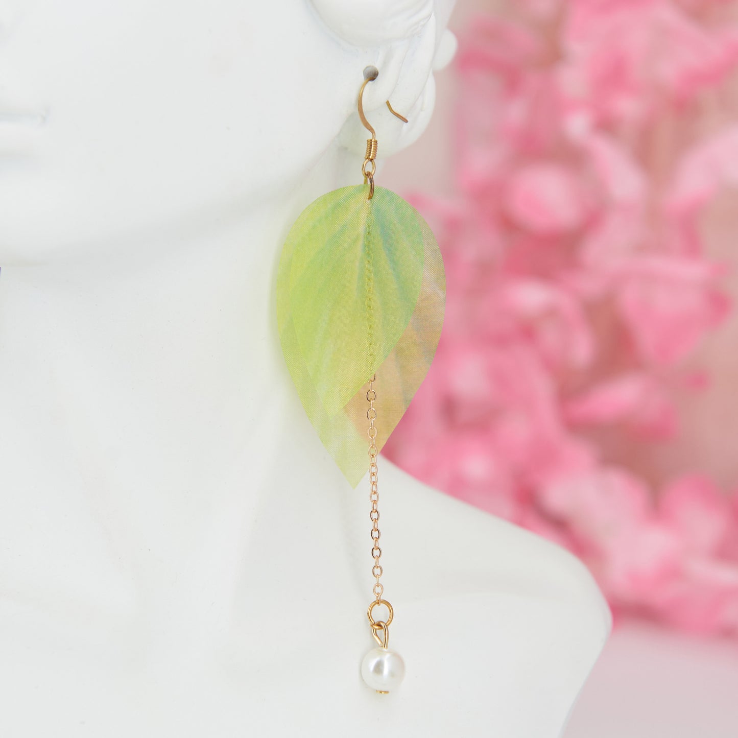 Extra-long dangle earrings inspired by lily of the valley. Lightweight fabric leaves and artificial pearl for a natural, refined look. 10 cm long. Zinc alloy for durability.