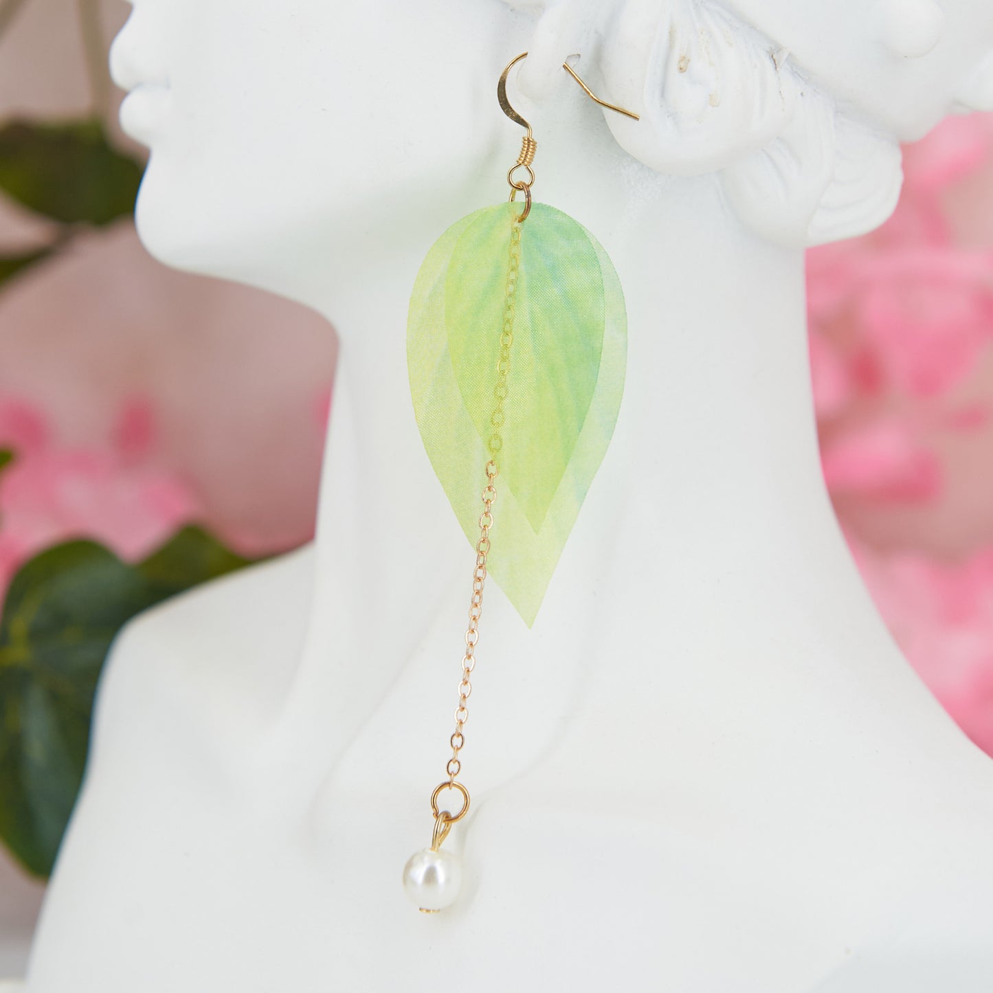 Extra-long dangle earrings inspired by lily of the valley. Lightweight fabric leaves and artificial pearl for a natural, refined look. 10 cm long. Zinc alloy for durability.