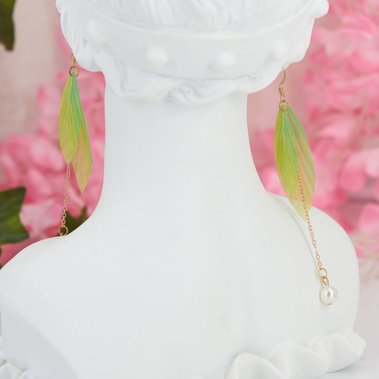 Extra-long dangle earrings inspired by lily of the valley. Lightweight fabric leaves and artificial pearl for a natural, refined look. 10 cm long. Zinc alloy for durability.