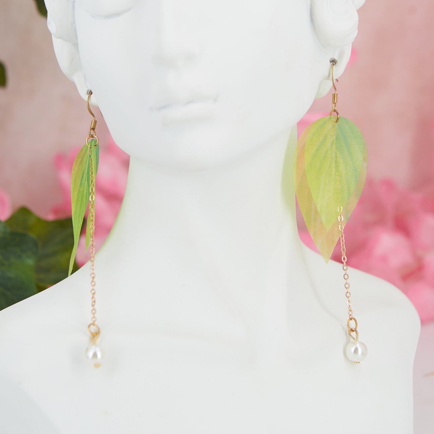 Extra-long dangle earrings inspired by lily of the valley. Lightweight fabric leaves and artificial pearl for a natural, refined look. 10 cm long. Zinc alloy for durability.