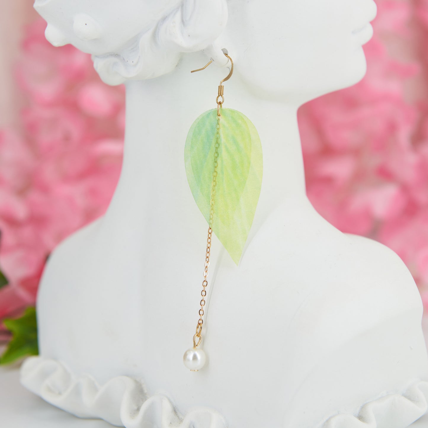 Extra-long dangle earrings inspired by lily of the valley. Lightweight fabric leaves and artificial pearl for a natural, refined look. 10 cm long. Zinc alloy for durability.