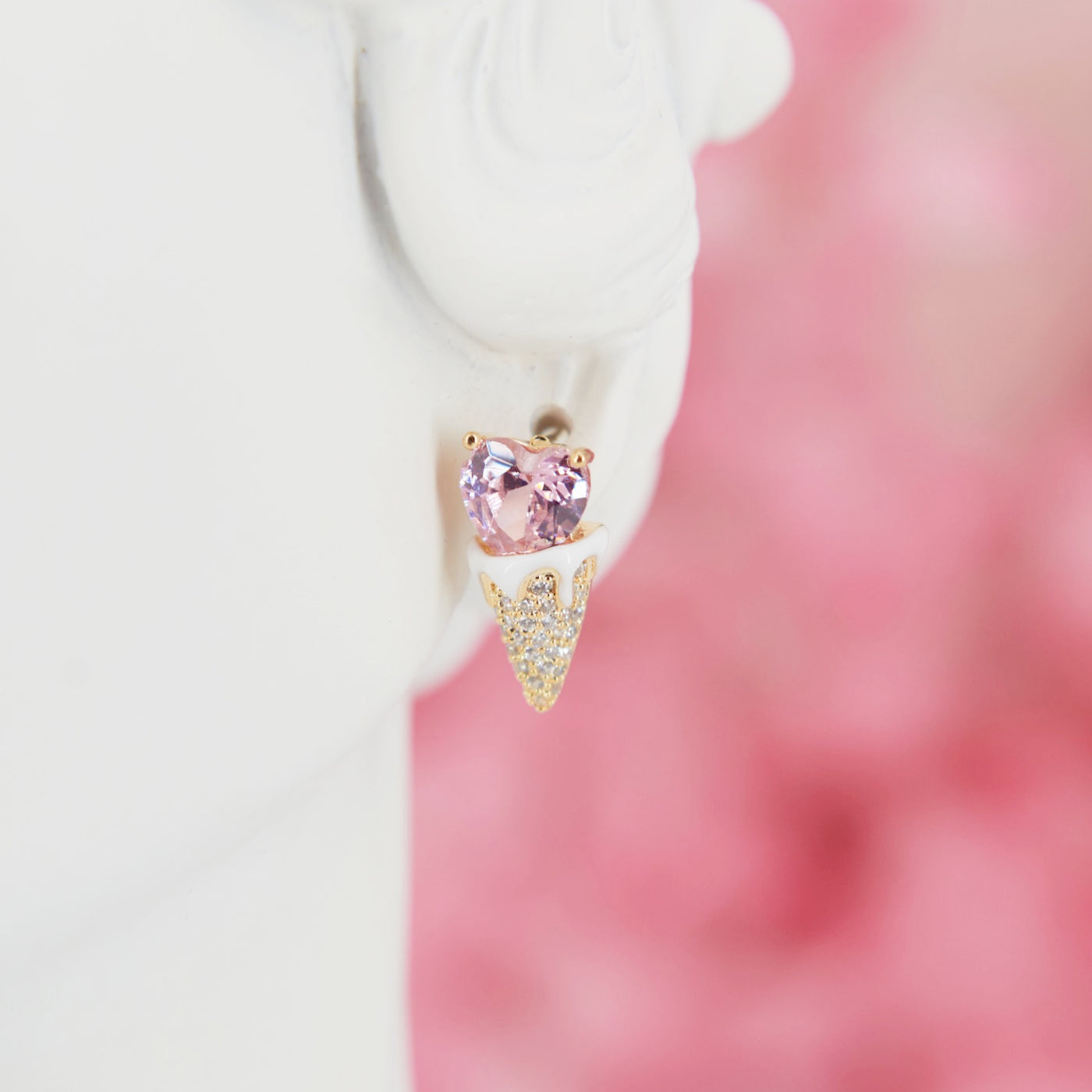 Earrings shaped like a cute ice cream cone with a soft pink heart in zircon. Embellished with sparkling zircons for a feminine touch. Perfect for adding summer sweetness to your look.