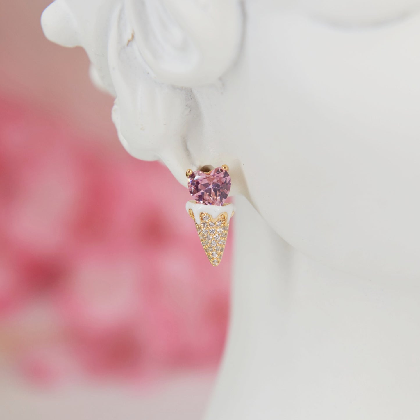 Earrings shaped like a cute ice cream cone with a soft pink heart in zircon. Embellished with sparkling zircons for a feminine touch. Perfect for adding summer sweetness to your look.