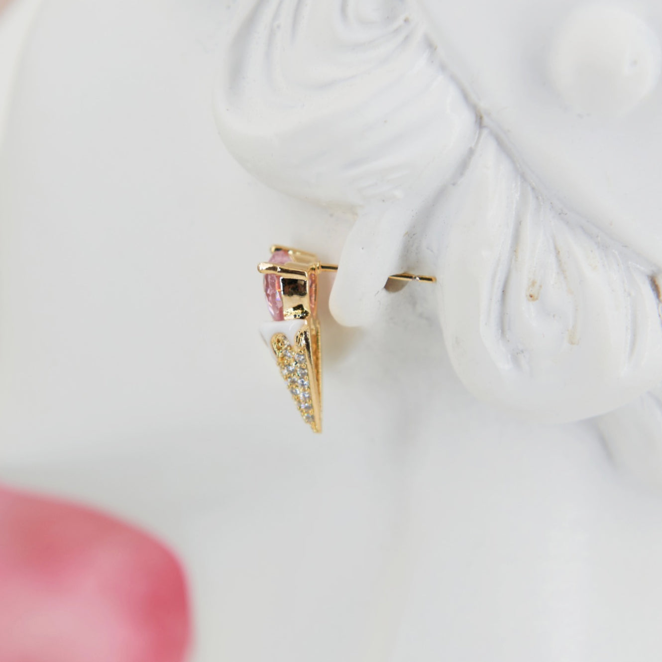 Earrings shaped like a cute ice cream cone with a soft pink heart in zircon. Embellished with sparkling zircons for a feminine touch. Perfect for adding summer sweetness to your look.