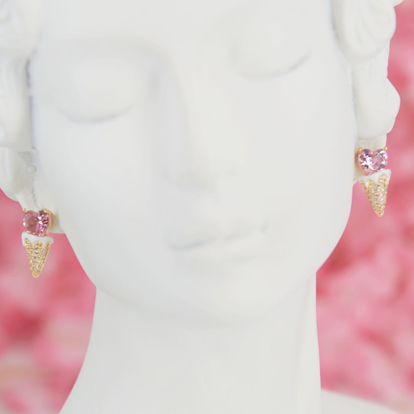 Earrings shaped like a cute ice cream cone with a soft pink heart in zircon. Embellished with sparkling zircons for a feminine touch. Perfect for adding summer sweetness to your look.