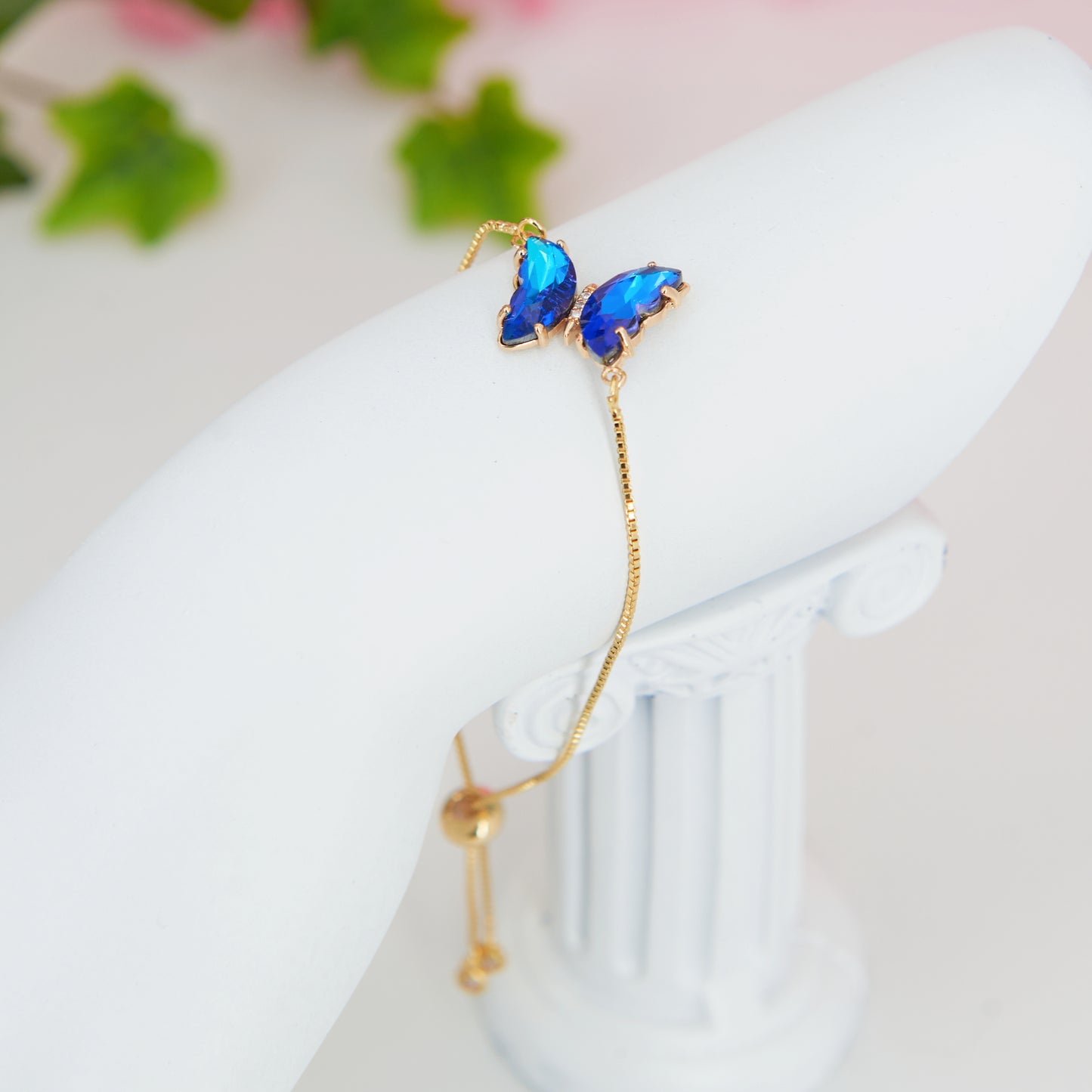 Fairycore Blue Butterfly sparkling pendant bracelet with gold chain and a slider for adjustment.