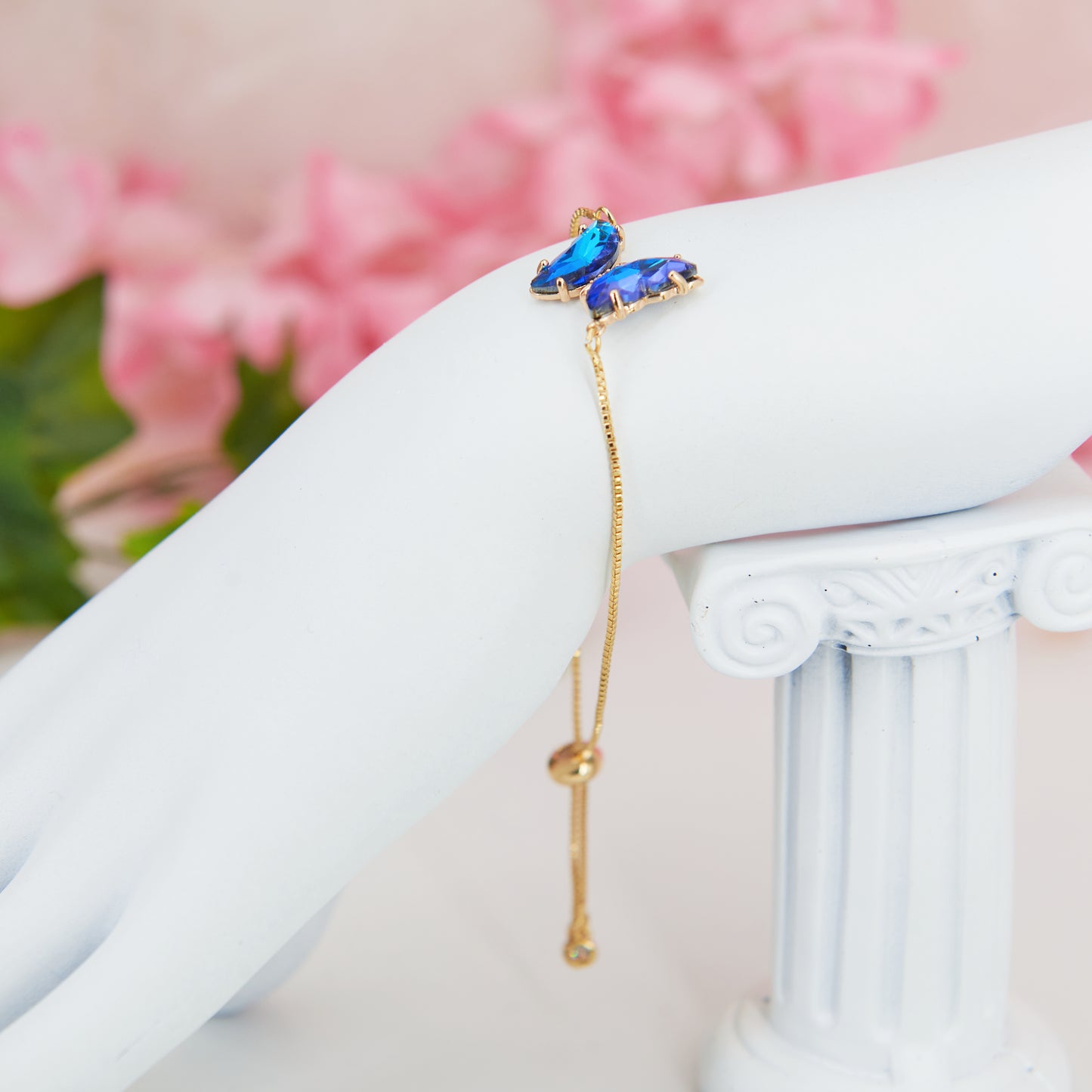 Fairycore Blue Butterfly sparkling pendant bracelet with gold chain and a slider for adjustment.